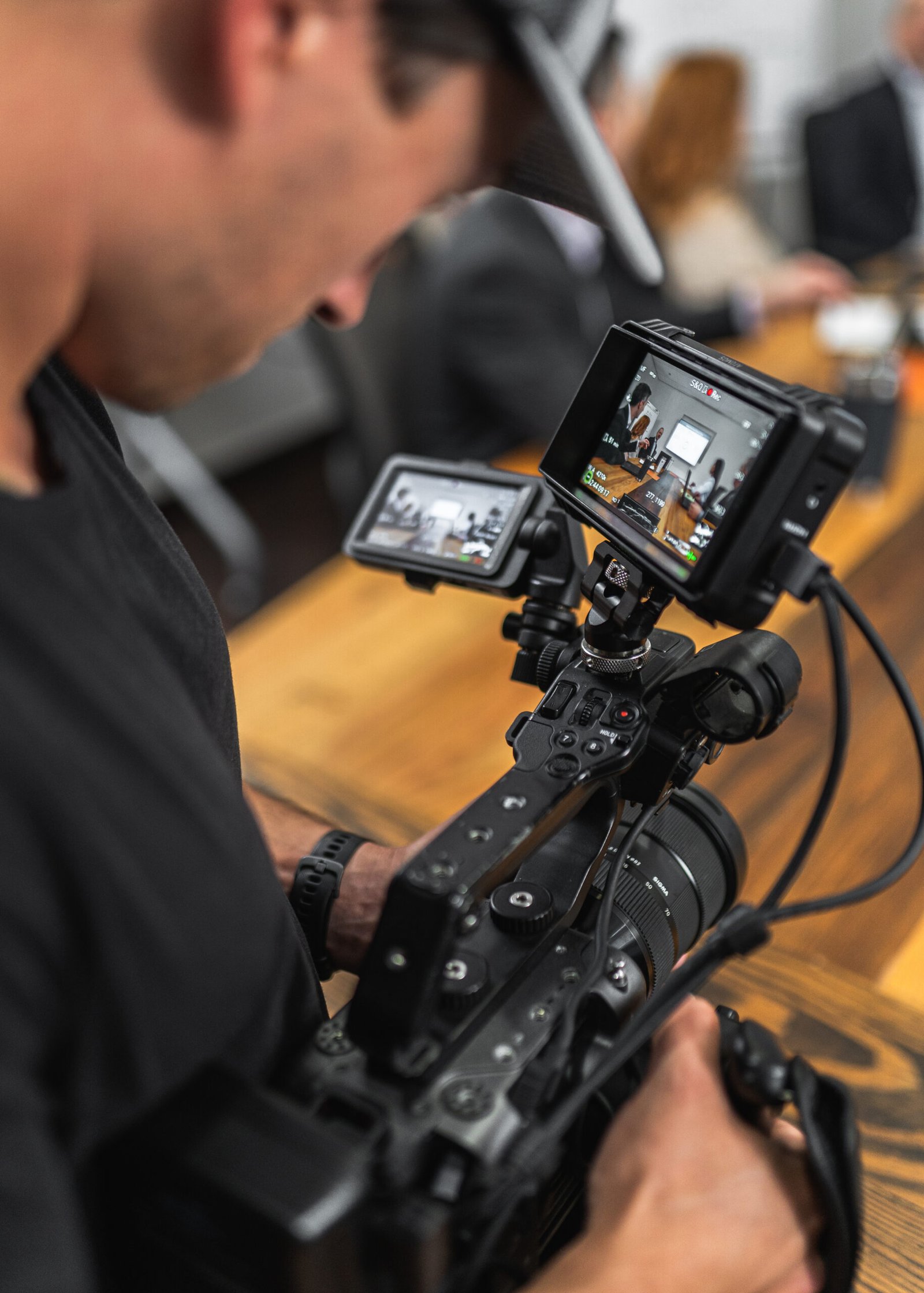 Man looking into camera monitor